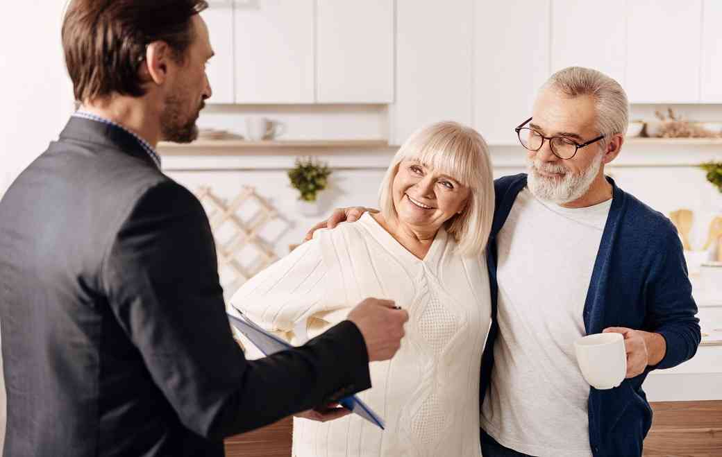 life-insurance-agent-presenting-guaranteed-issue-life-insurance-policy-to-old-couple