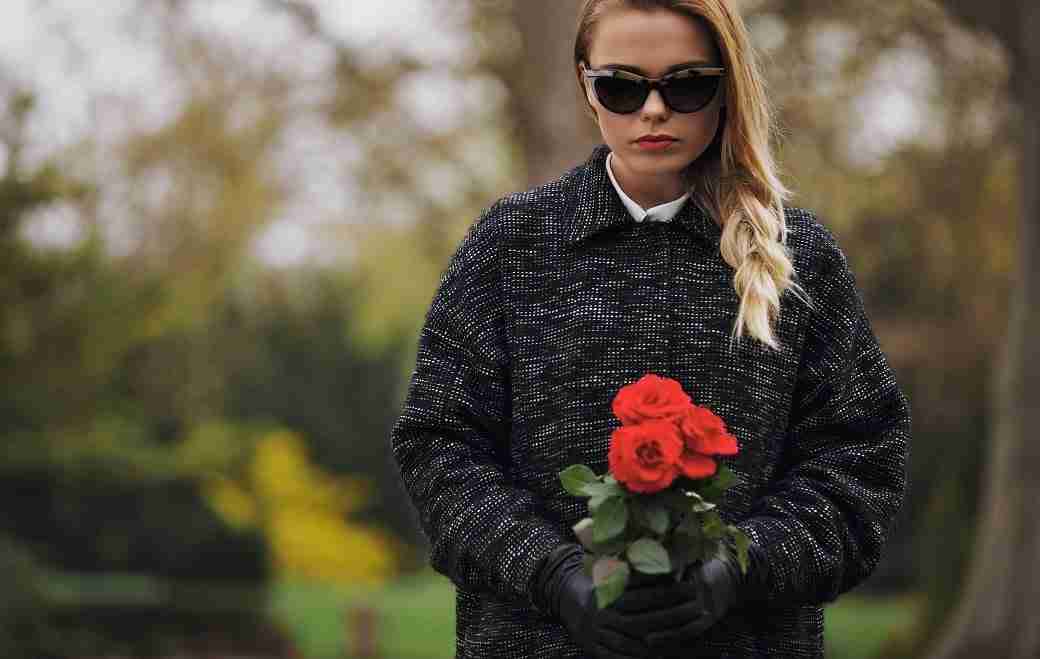 young-woman-at-graveyard-with-fresh-roses