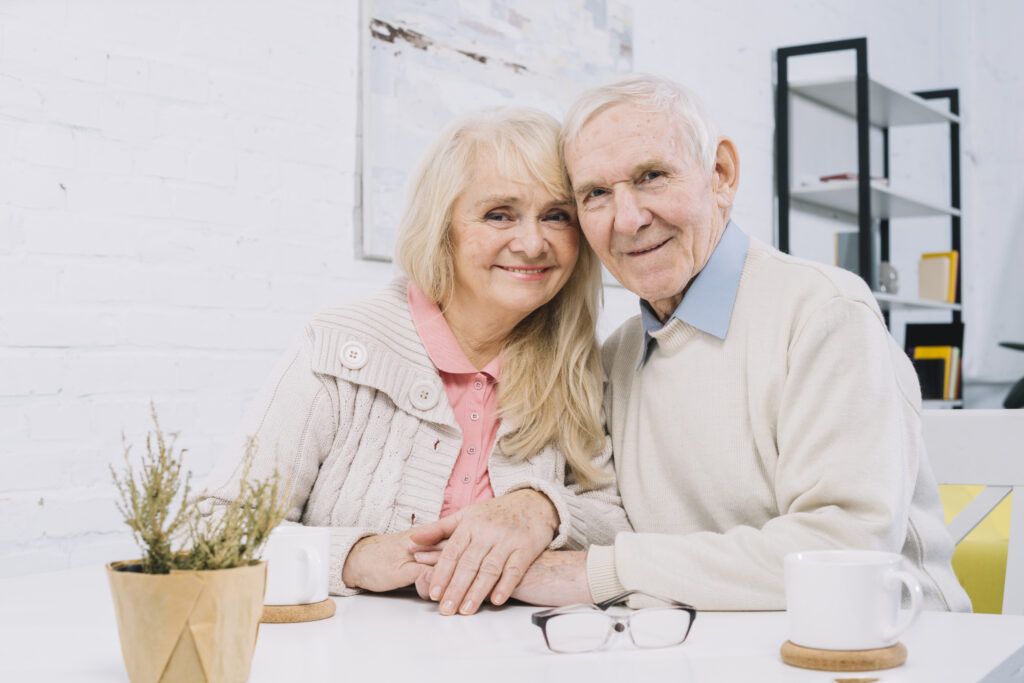 senior-couple-table-holding-hands