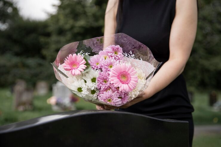 close-up-woman-visiting-grave-loved-one